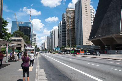 City street and buildings against sky