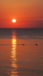 Scenic view of sea against orange sky