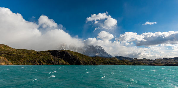 Panoramic view of sea and mountains against sky