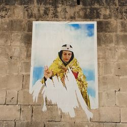 Portrait of woman against wall