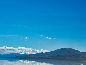 Scenic view of mountains against blue sky