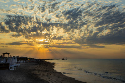 Scenic view of beach against sky during sunset