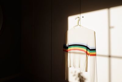 Close-up of multi colored sweater hanging on door