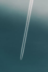 Low angle view of airplane flying against sky