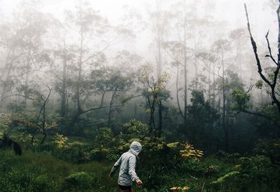 Full length of man on grass against trees