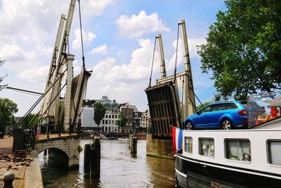 Boats in harbor with city in background