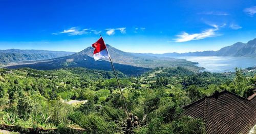 Scenic view of mountains against blue sky