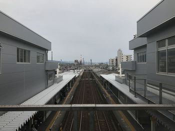 High angle view of railroad tracks amidst buildings in city