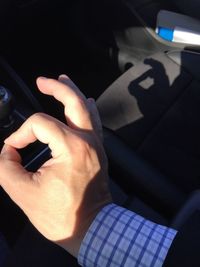 Close-up of man hand in car