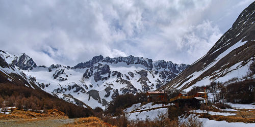 Scenic view of snow covered mountains against sky