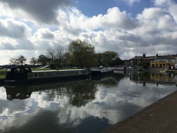 Boats moored in lake against sky