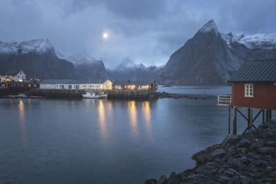 Scenic view of lake by buildings against sky