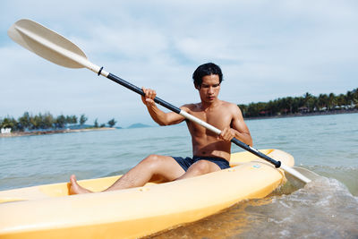 Portrait of man kayaking in sea