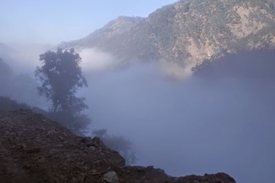 Scenic view of mountains against sky during foggy weather