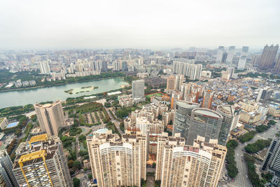 High angle view of modern buildings in city against sky