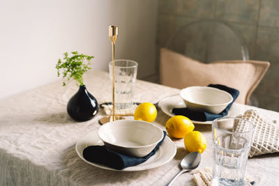 Vintage table setting with linen napkins and yellow lemons.
