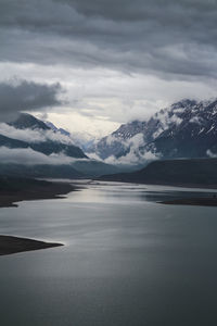 Scenic view of lake and mountains against sky