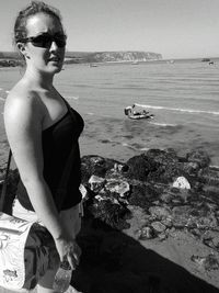 Woman standing by sea