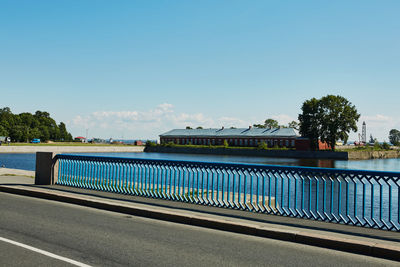 Road by trees against sky