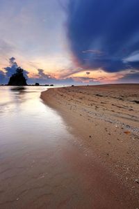 Scenic view of beach against sky during sunset
