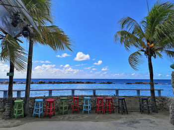 Palm trees on beach against sky