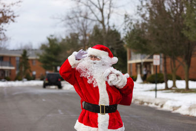 Santa standing on road during christmas