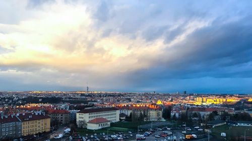 View of cityscape against cloudy sky