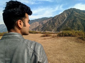 Rear view of man looking at mountains