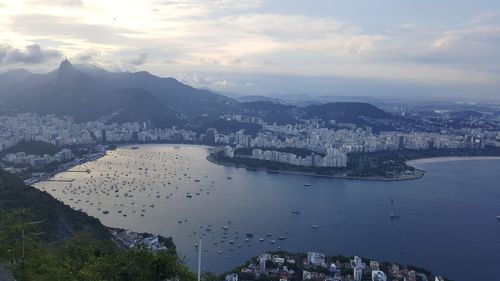 High angle view of buildings by sea against sky