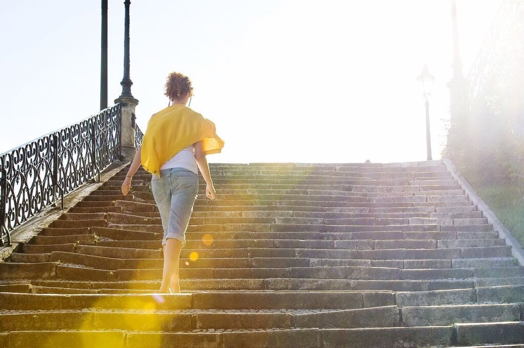 full length, rear view, lifestyles, built structure, architecture, walking, standing, casual clothing, building exterior, men, steps, leisure activity, wall - building feature, steps and staircases, staircase, person, low angle view, clear sky