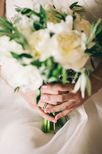 Midsection of woman holding flower bouquet