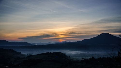 Scenic view of mountains against dramatic sky