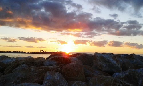 Scenic view of dramatic sky over sea during sunset