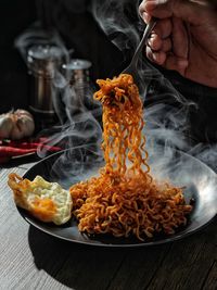 Cropped hand of person preparing food