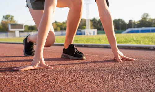 Low section of woman running