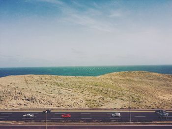 Road by sea against sky