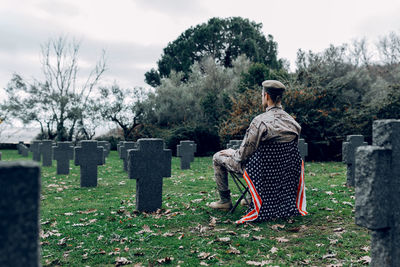 People in cemetery against sky