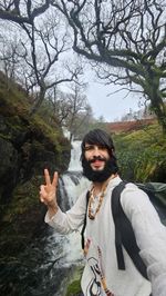 Low angle view of woman standing against sky