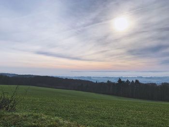 Scenic view of field against sky during sunset