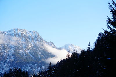 Scenic view of snowcapped mountains against clear blue sky