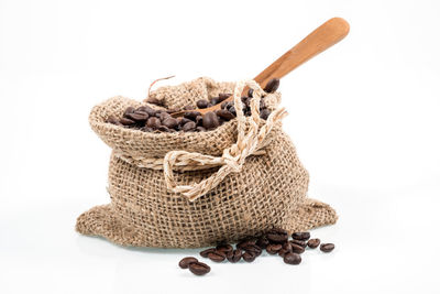 Close-up of bread in basket against white background