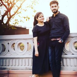 Portrait of a smiling young couple standing outdoors