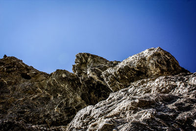 Low angle view of mountain against clear blue sky