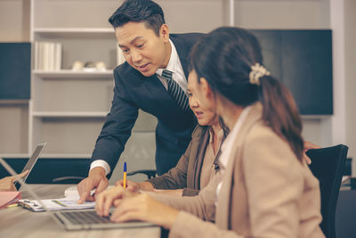 Business colleagues working at table