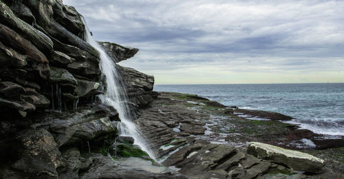 Scenic view of sea against cloudy sky