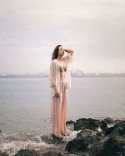 Rear view of woman standing in water