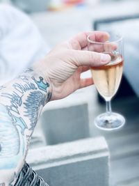 Cropped hand of woman holding wineglass