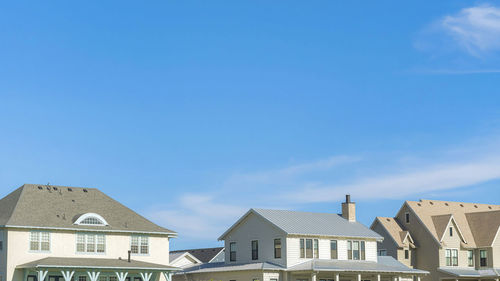 Low angle view of buildings against clear blue sky