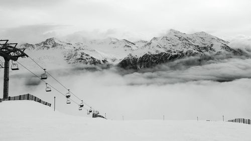 Ski lift on snow covered landscape