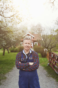 Portrait of confident farmer standing on pathway